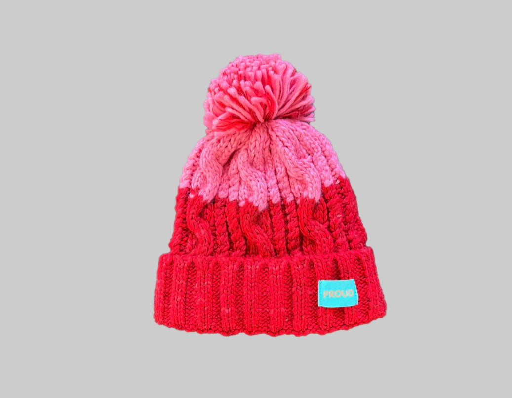 Silky lined pom pom hat in red and pink with proud logo