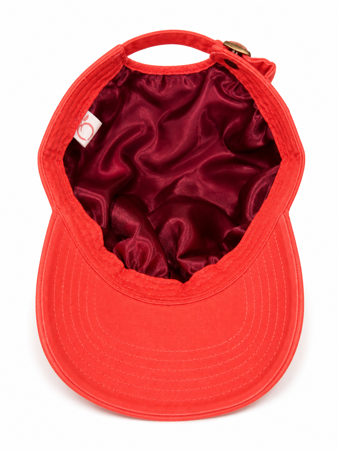 The proud peach silky lined PEACHY cap in coral
