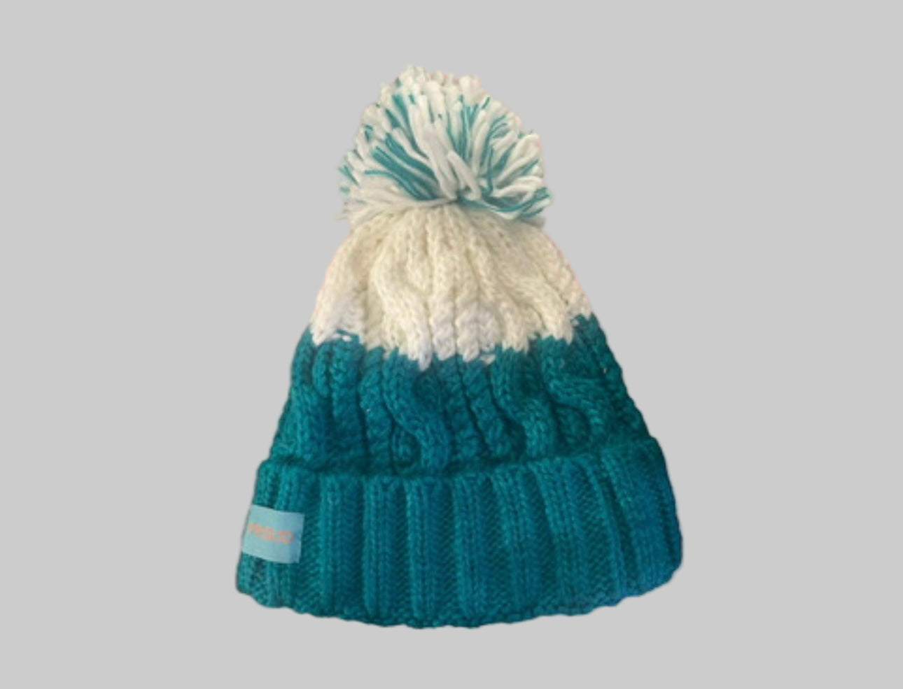 Proud peach silky lined beanie with bobble in teal and cream